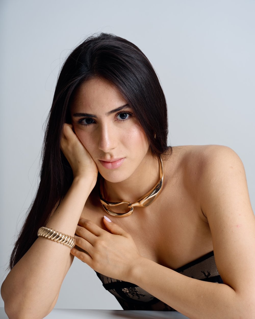 Soft glam makeup with gold jewelry — studio editorial