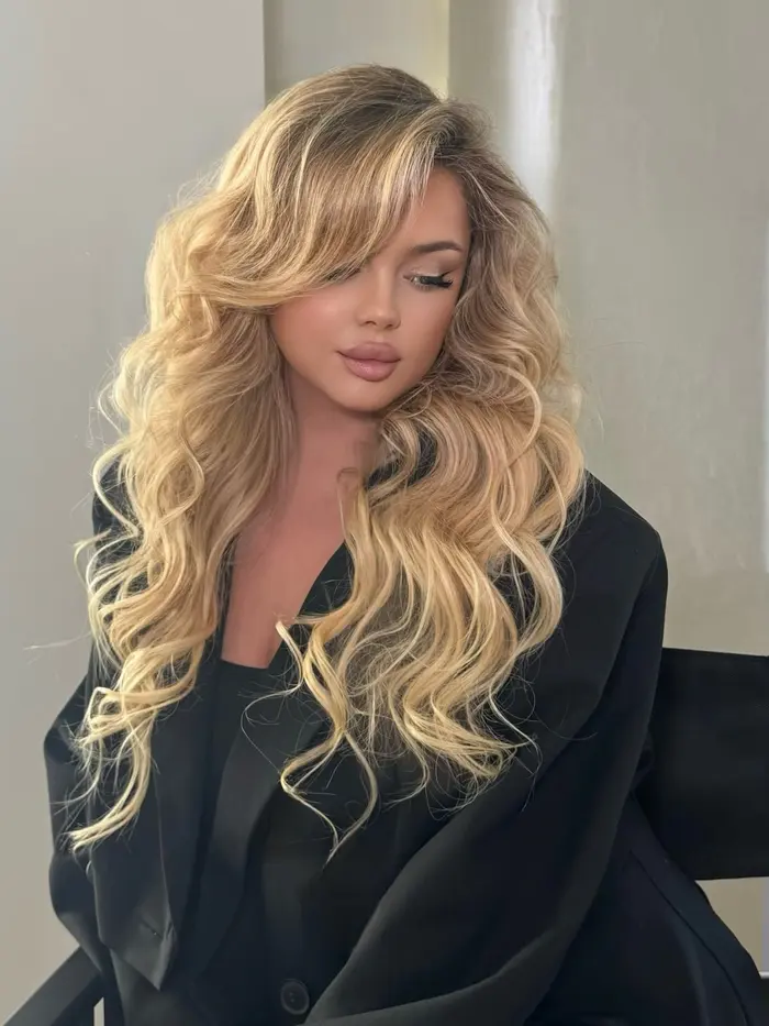 Voluminous blonde waves with soft glam makeup