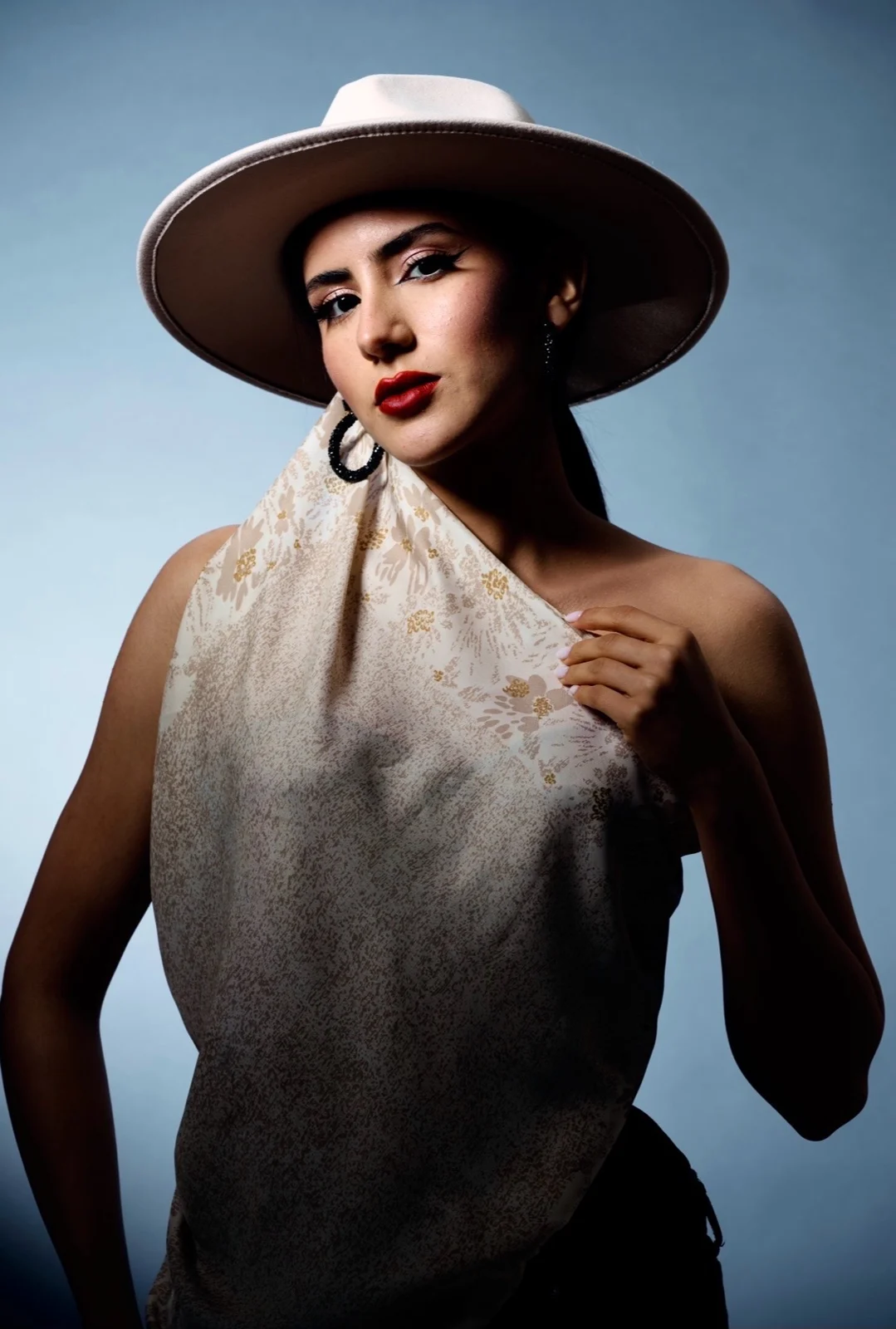 Editorial hat look with classic red lip — makeup by Glam On Call